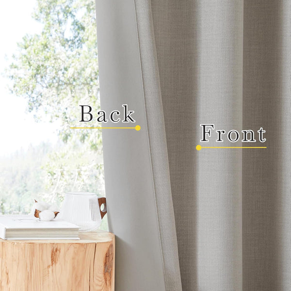 Light grey woven curtain showing its textured front and smoother back fabric. Hanging by a window.