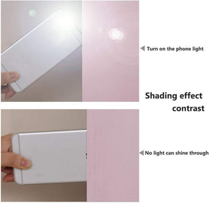Light pink blackout fabric demonstrating its full light-blocking capability with a phone flashlight test.