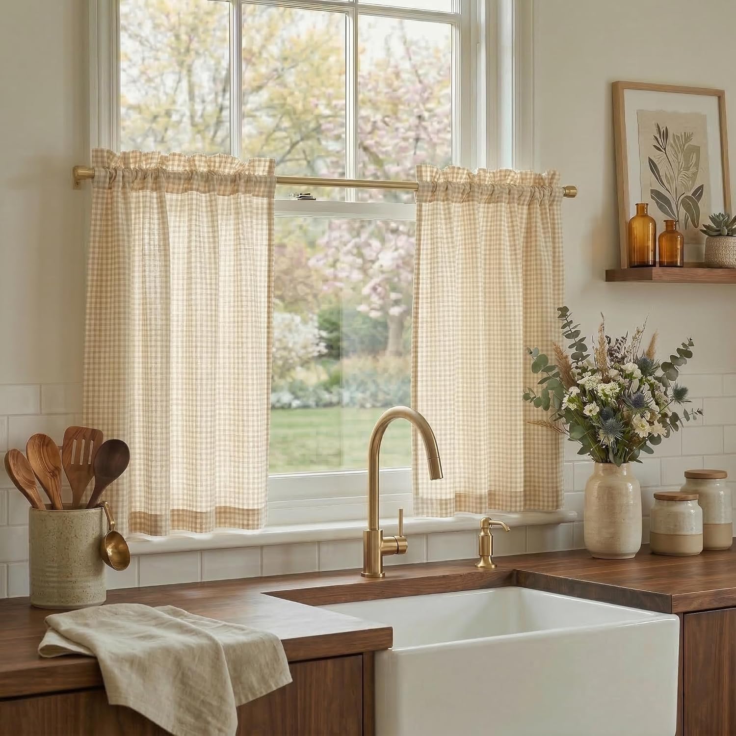 Light tan and white gingham cafe curtains with a rod pocket top, hanging in a bright kitchen window.