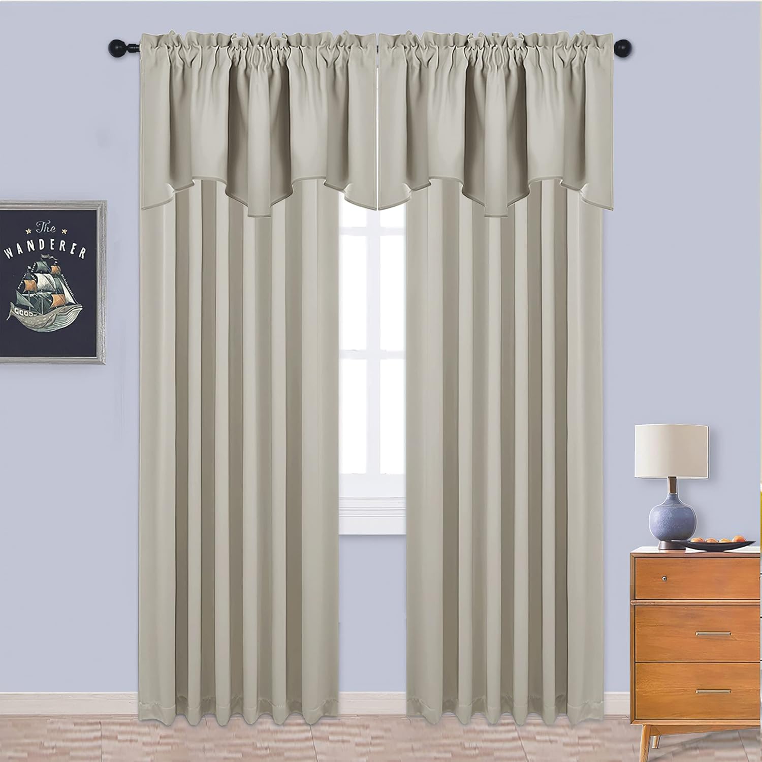 Light taupe rod pocket curtains with attached scalloped valance hanging over a window.