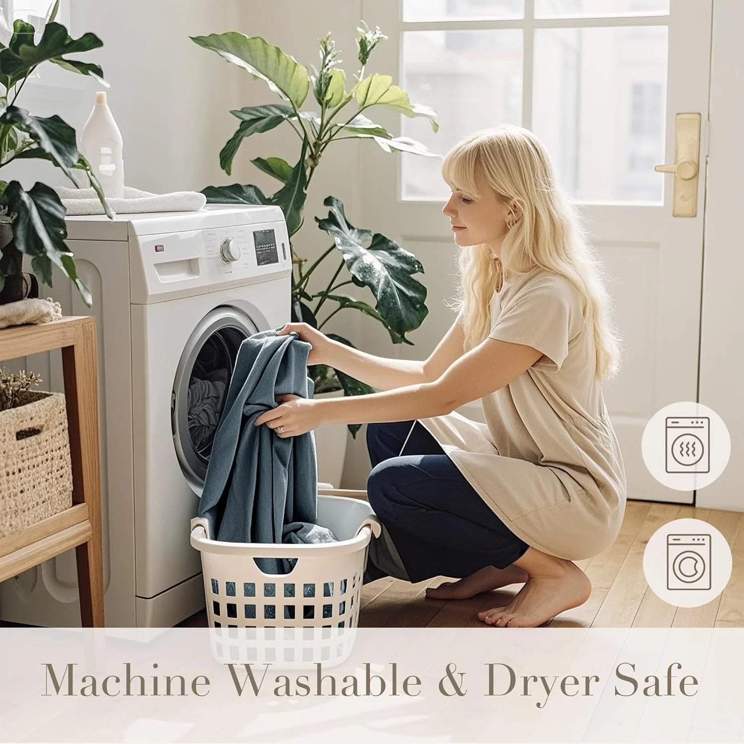Woman loading blue fabric into a front-load washer in a bright, plant-filled laundry room