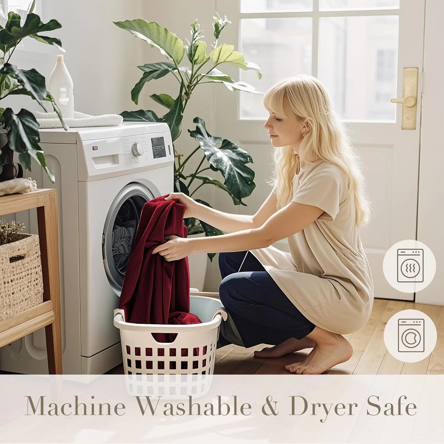 Woman loading burgundy fabric into a front-load washer in a bright laundry room