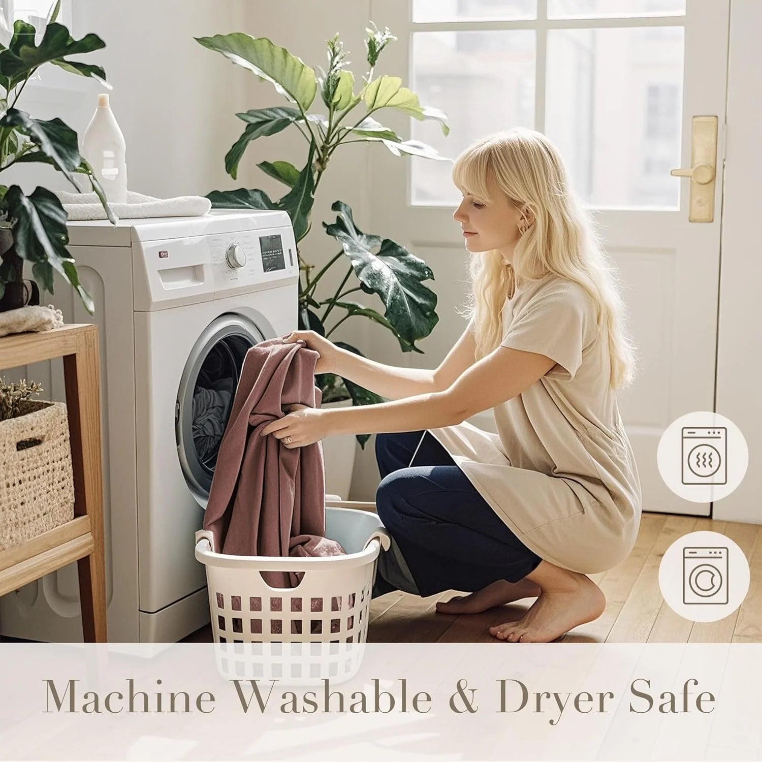 Woman loading mauve fabric into a front-load washer in a bright modern laundry room