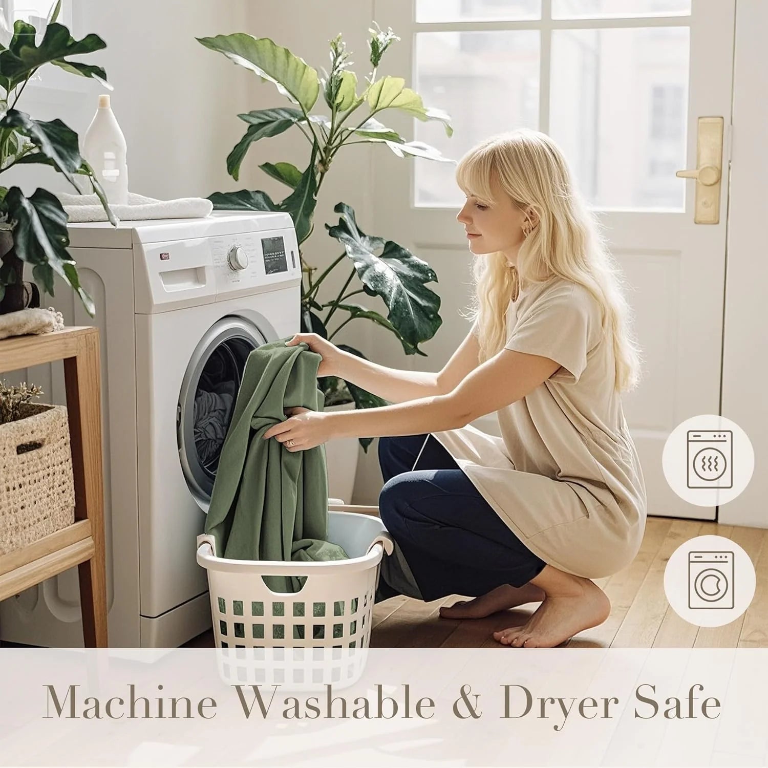 Woman loading soft green fabric into a front-load washer in a bright laundry room