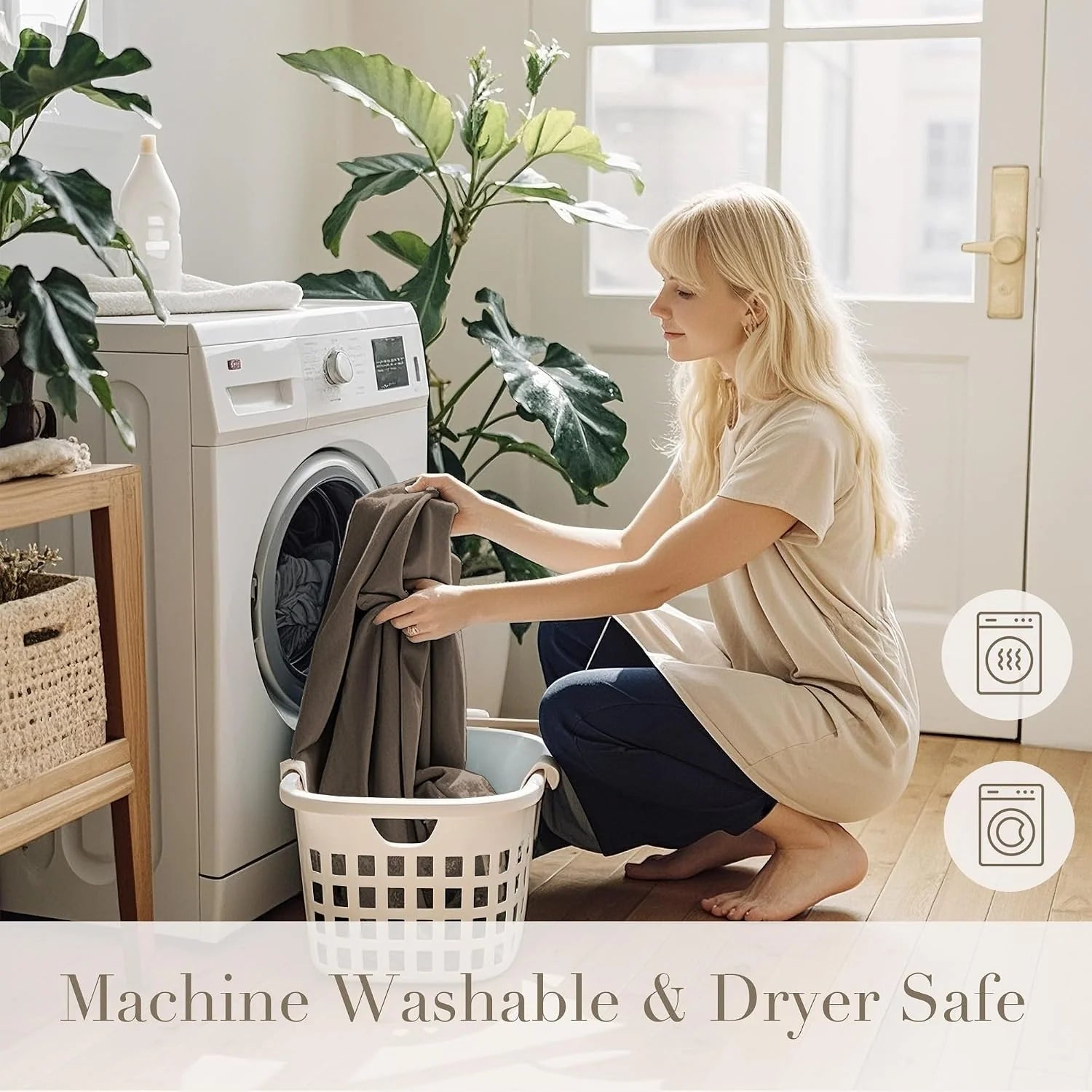 Woman loading taupe fabric into a front-load washer in a bright laundry room