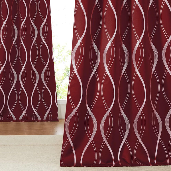 Deep maroon curtains with a modern white abstract wavy line pattern hanging by a window.