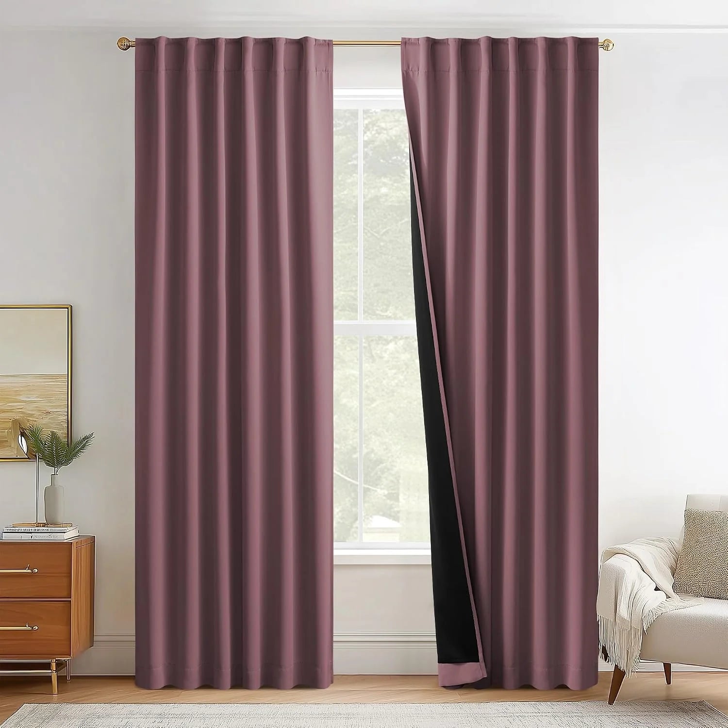 Mauve blackout curtains on a gold rod in a bright modern living room window