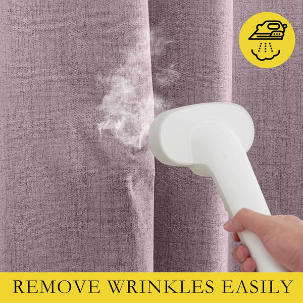 Close-up of a hand using a white handheld steamer on a textured mauve curtain, effectively removing wrinkles.