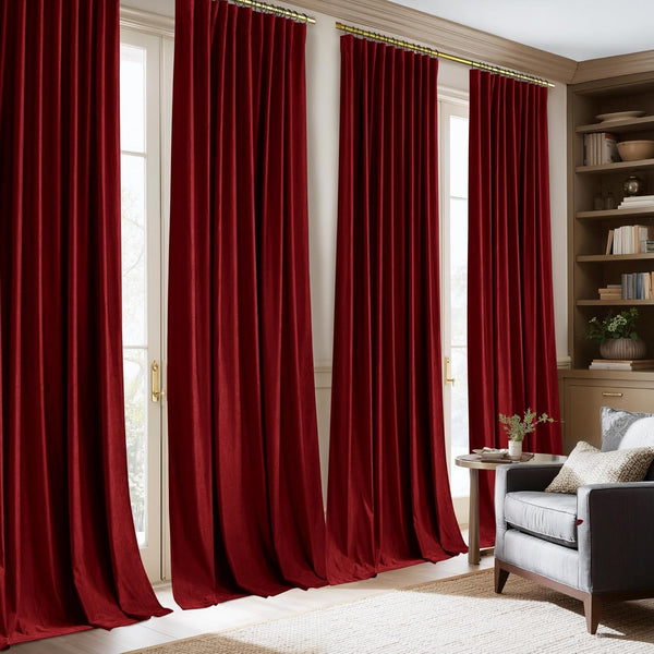 Luxurious merlot velvet pinch pleat curtains with gold rings hang elegantly over tall windows.