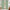 Mint green grommet top curtains providing room darkening, hung over a wooden patio door.