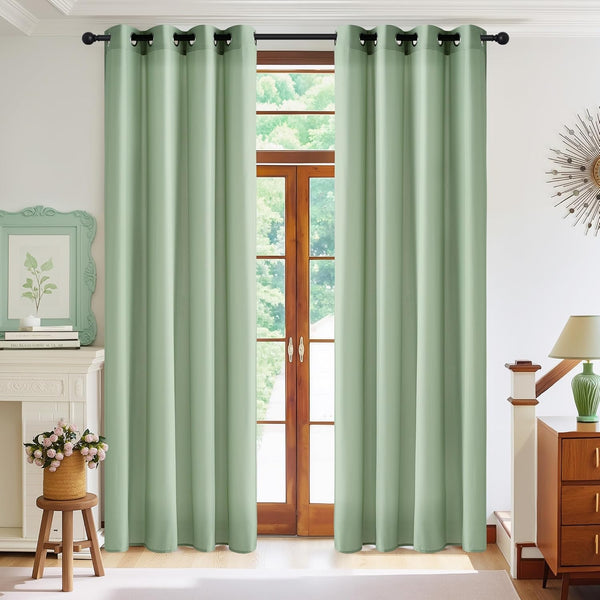 Mint green grommet top curtains providing room darkening, hung over a wooden patio door.