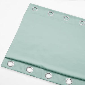 Smooth mint green curtain panel with silver grommet eyelets, shown folded on a white background.