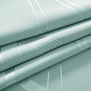 Close-up of light mint green woven fabric with shimmering metallic silver geometric stripes, folded.