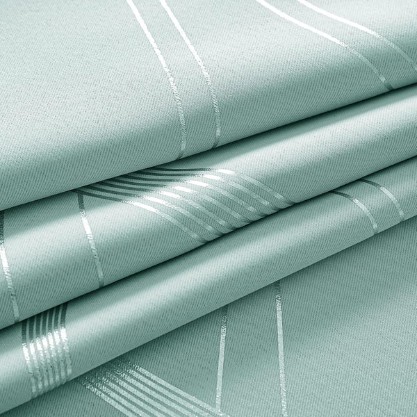 Close-up of light mint green woven fabric with shimmering metallic silver geometric stripes, folded.