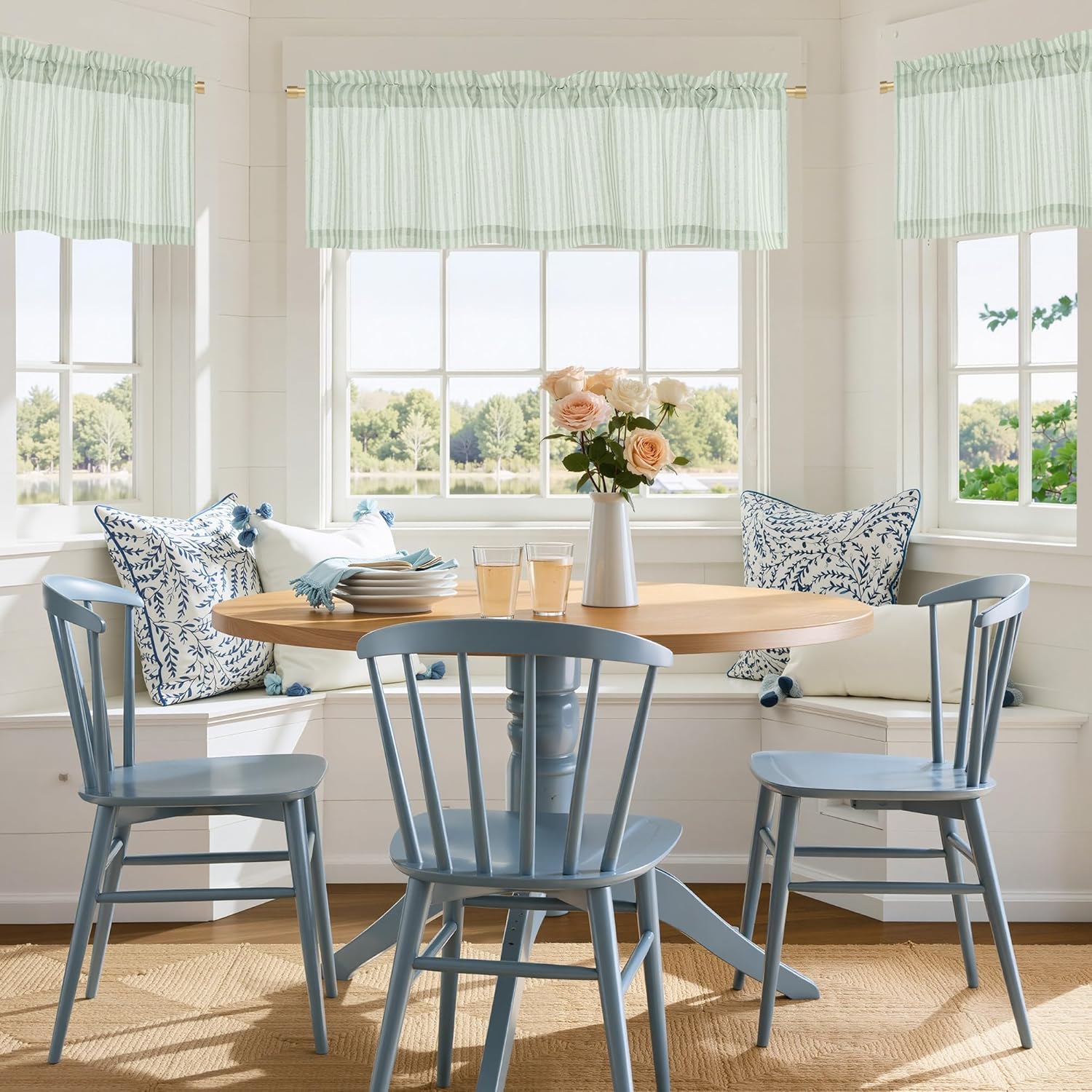Mint green and white striped rod pocket valance curtains hung above a sunlit dining nook window.