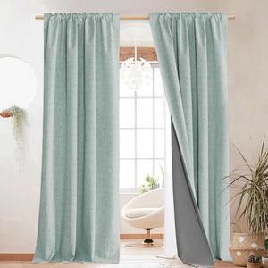 Textured mint green blackout curtains with dark gray lining, hanging with a gathered rod pocket top.