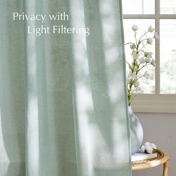 Mint green light filtering curtain with textured linen-look fabric. Offers privacy and soft light.