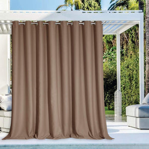 Mocha brown outdoor patio curtain with silver grommet top hangs from a white pergola providing privacy.
