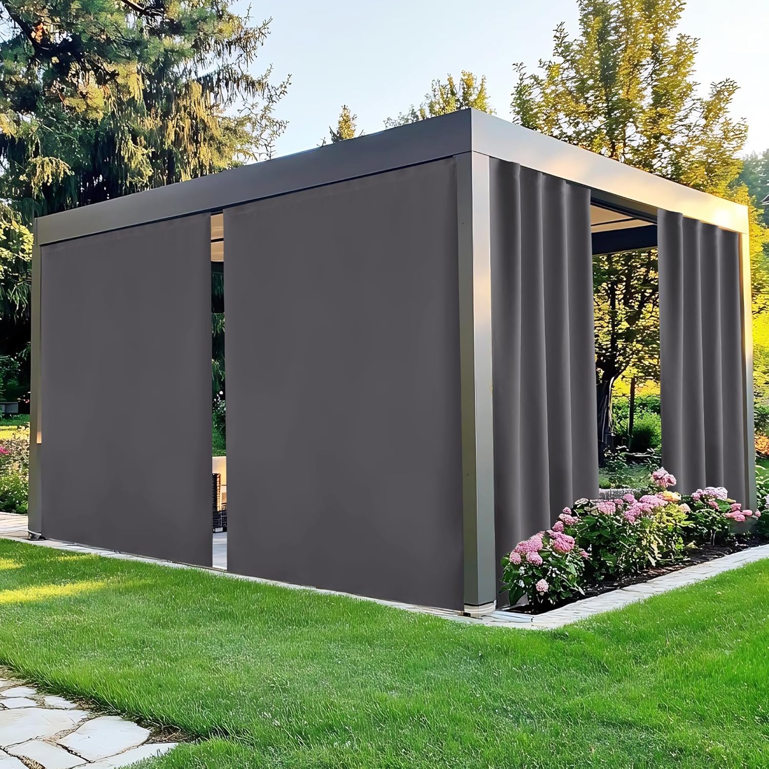 Modern dark gray outdoor pergola with retractable fabric side screens on a lush green lawn.