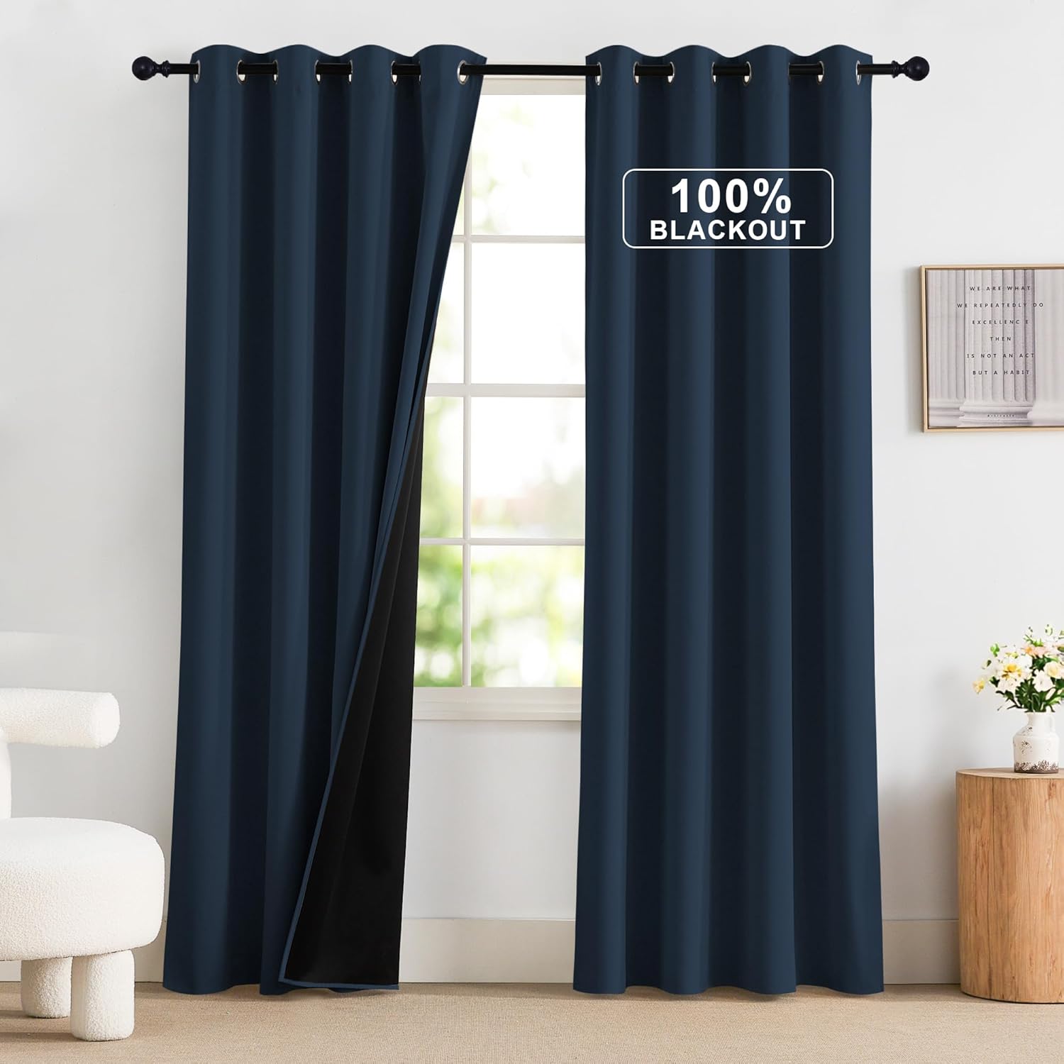 Modern navy blue 100% blackout grommet curtains hanging on a rod, one panel shows black backing.