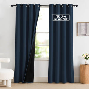 Modern navy blue 100% blackout grommet curtains hanging on a rod, one panel shows black backing.