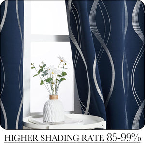 Navy blue blackout curtains feature a shimmering silver wave pattern, framing a bright window.