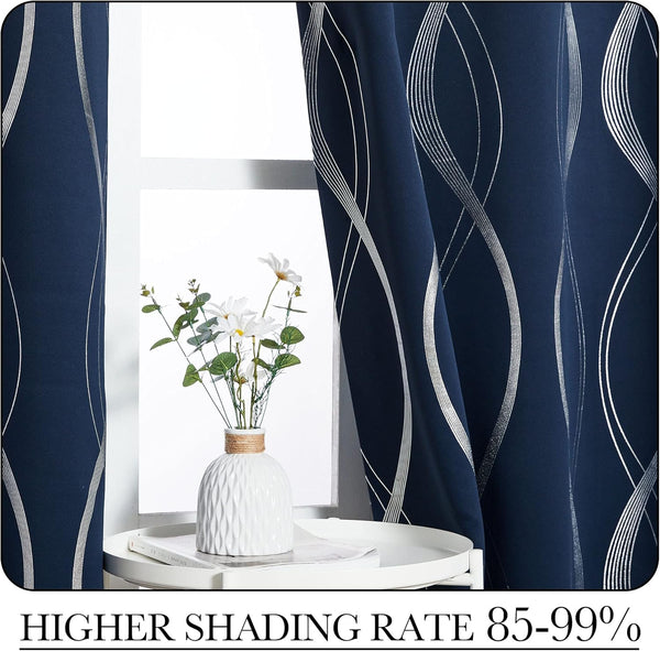 Navy blue blackout curtains feature a shimmering silver wave pattern, framing a bright window.