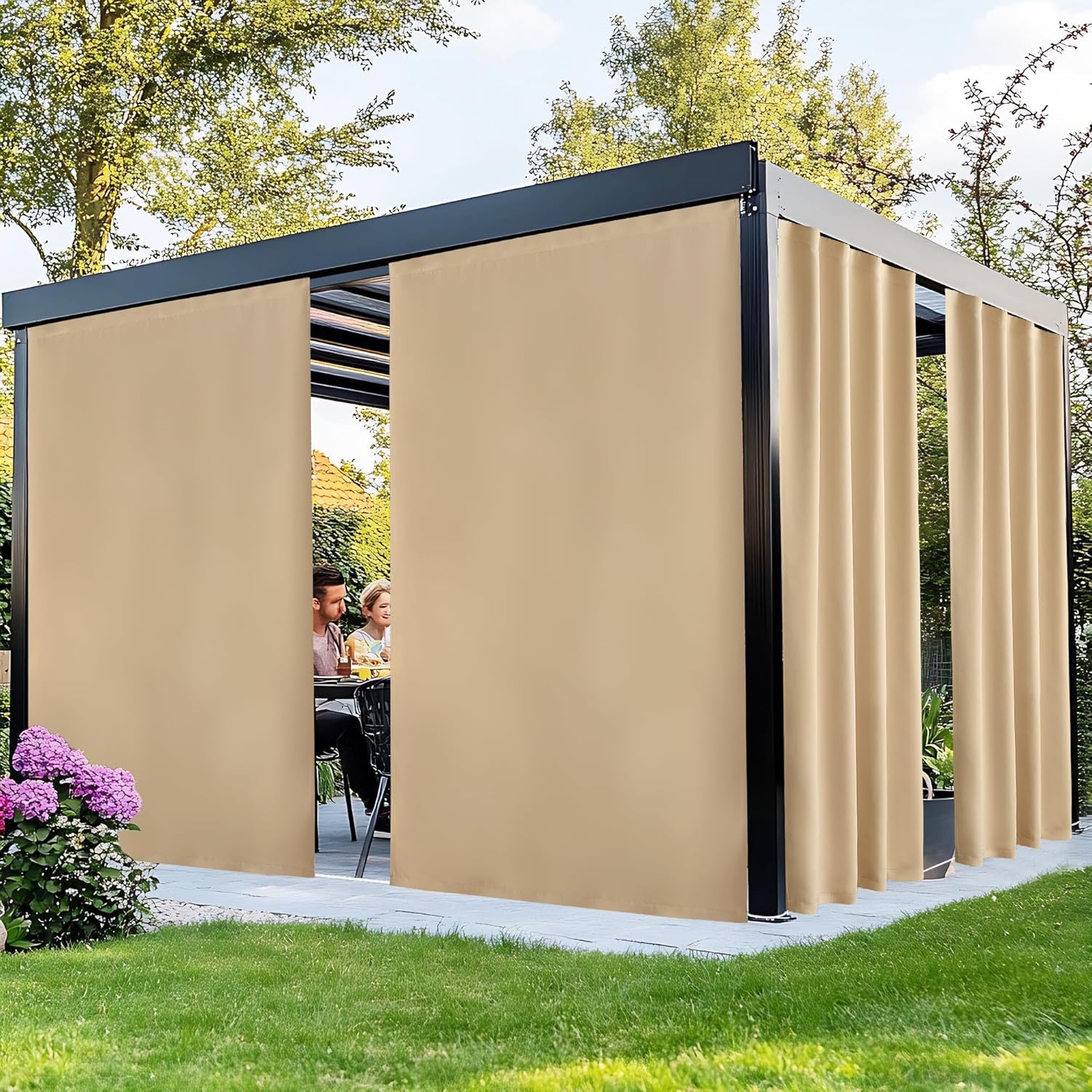 Modern black metal outdoor pergola featuring beige privacy curtains on a sunny patio. People dine inside, enjoying shade.