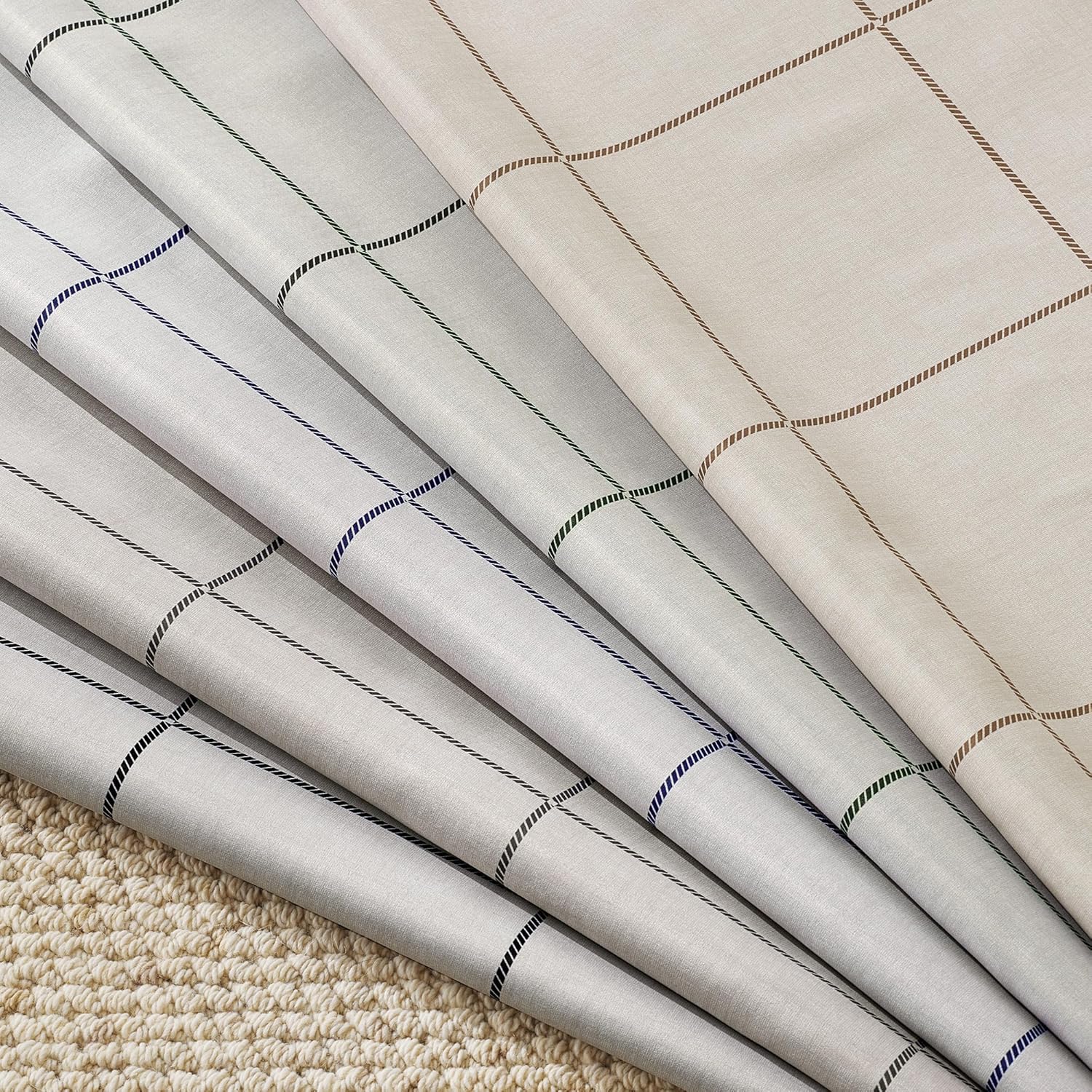 Textured fabrics with dashed windowpane checks: light grey with blue, black, green; beige with brown.