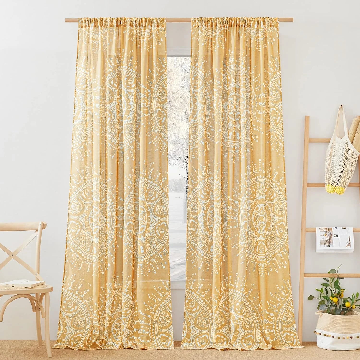 Mustard yellow boho curtains with white medallion print hanging in a bright room