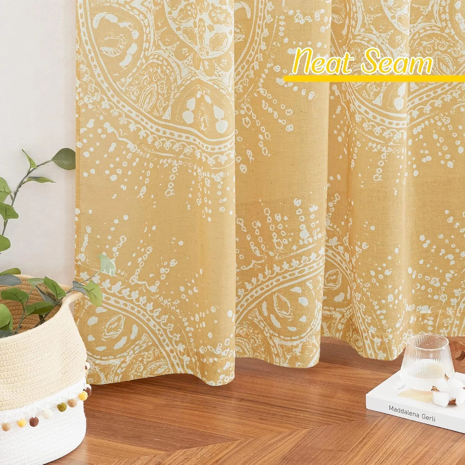 Mustard yellow paisley curtain panel with white print in a bright cozy room