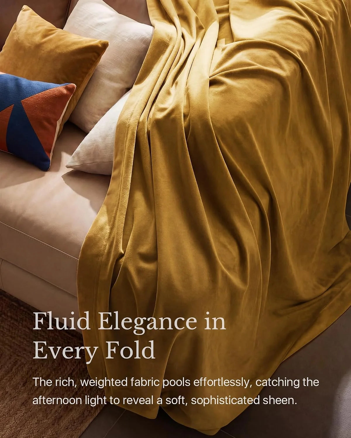 Mustard velvet throw draped over a beige sofa with colorful accent pillows