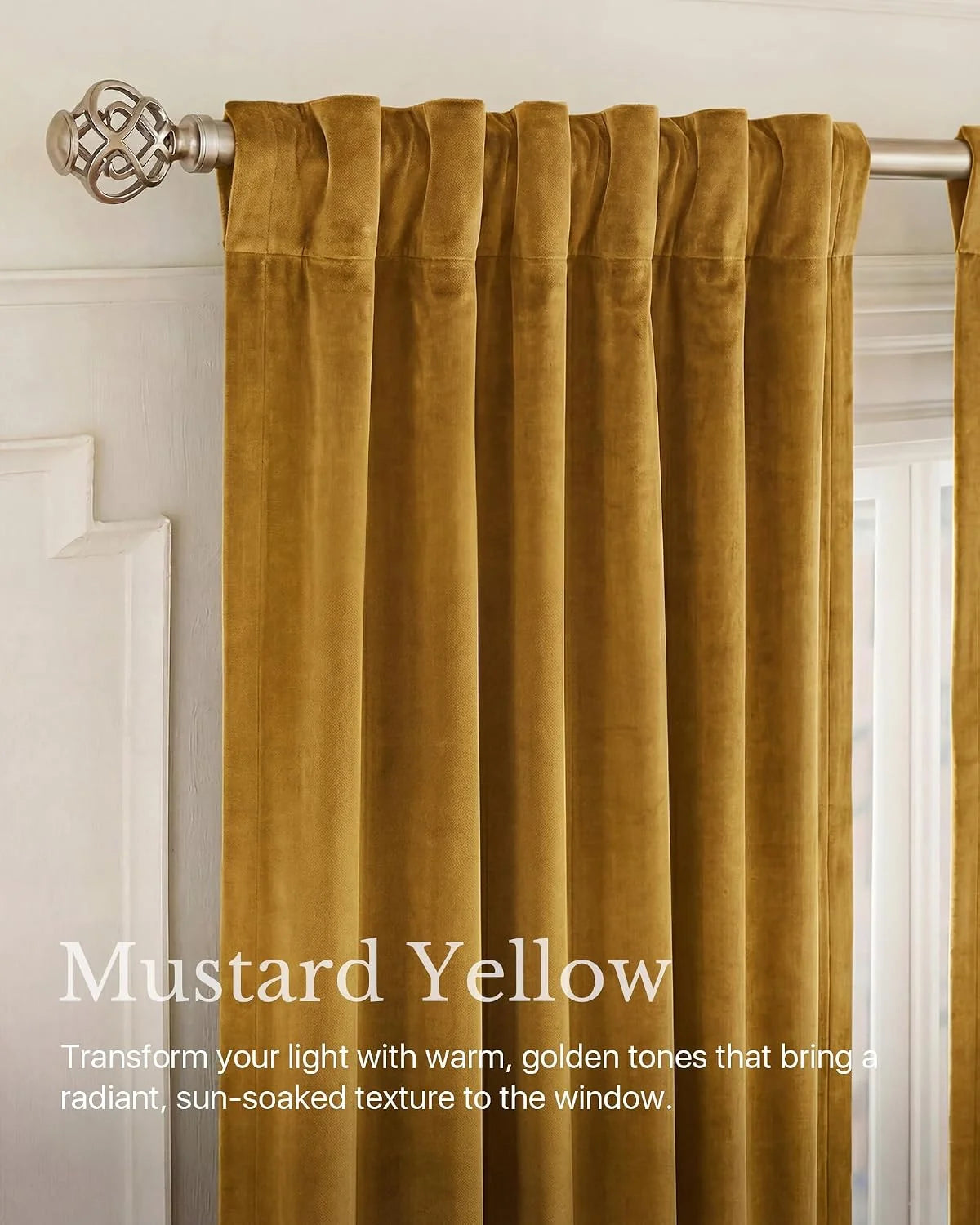 Mustard yellow velvet pleated curtains hanging on a brushed metal rod