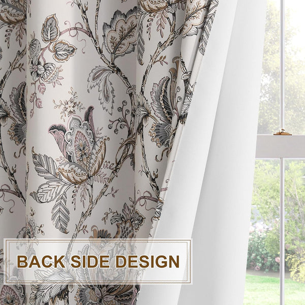 Muted gray and pink floral chinoiserie patterned curtain, showing its elegant front and plain white back lining by a window.