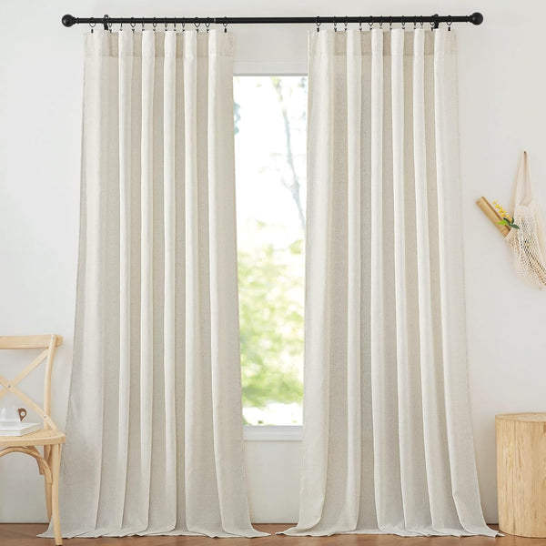 Two light beige natural linen blend pleated curtains hang on a black rod, filtering sunlight.