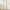 Natural beige linen blend curtains with rod pocket top hanging on a light wooden rod.
