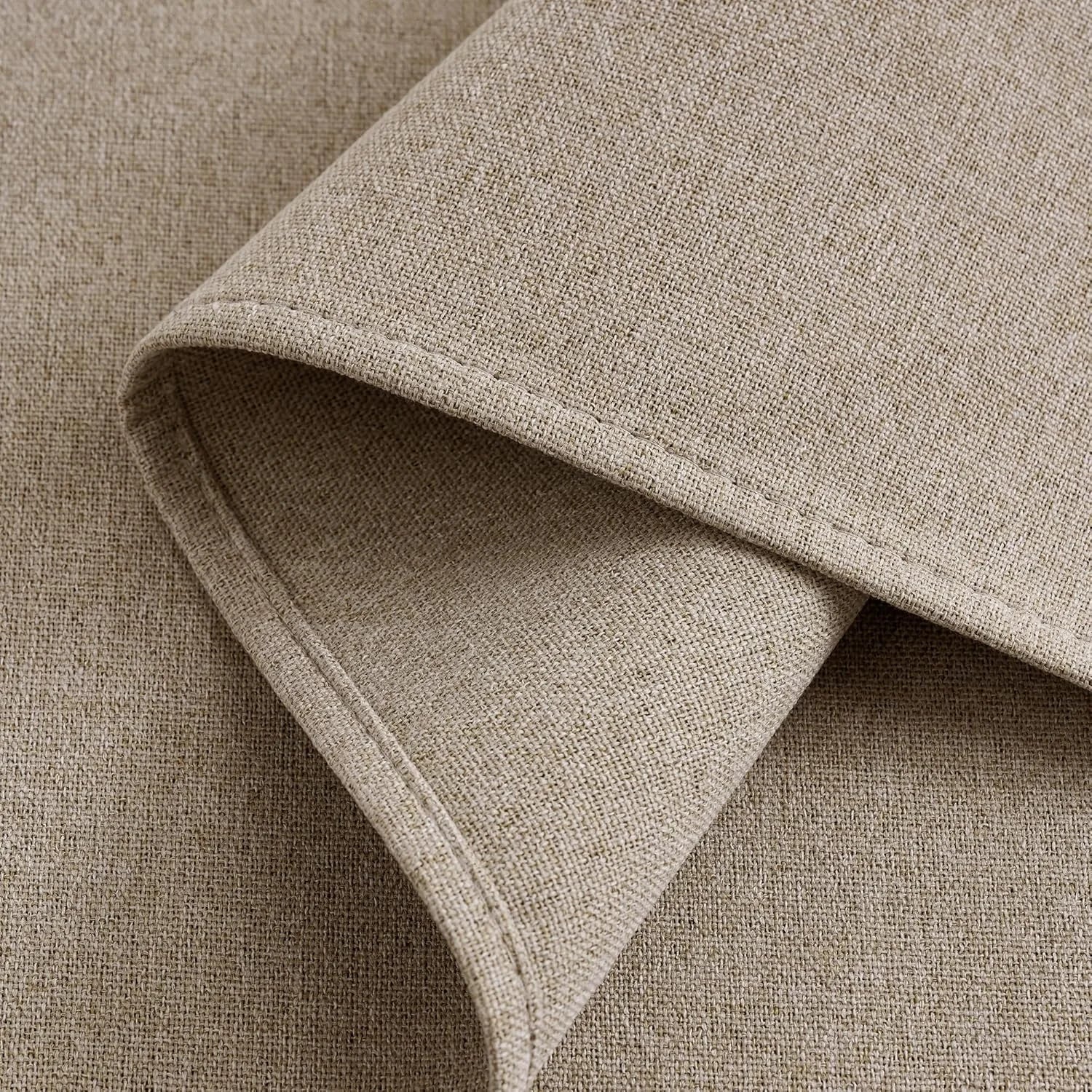 Close-up of folded natural beige linen-look fabric with visible texture