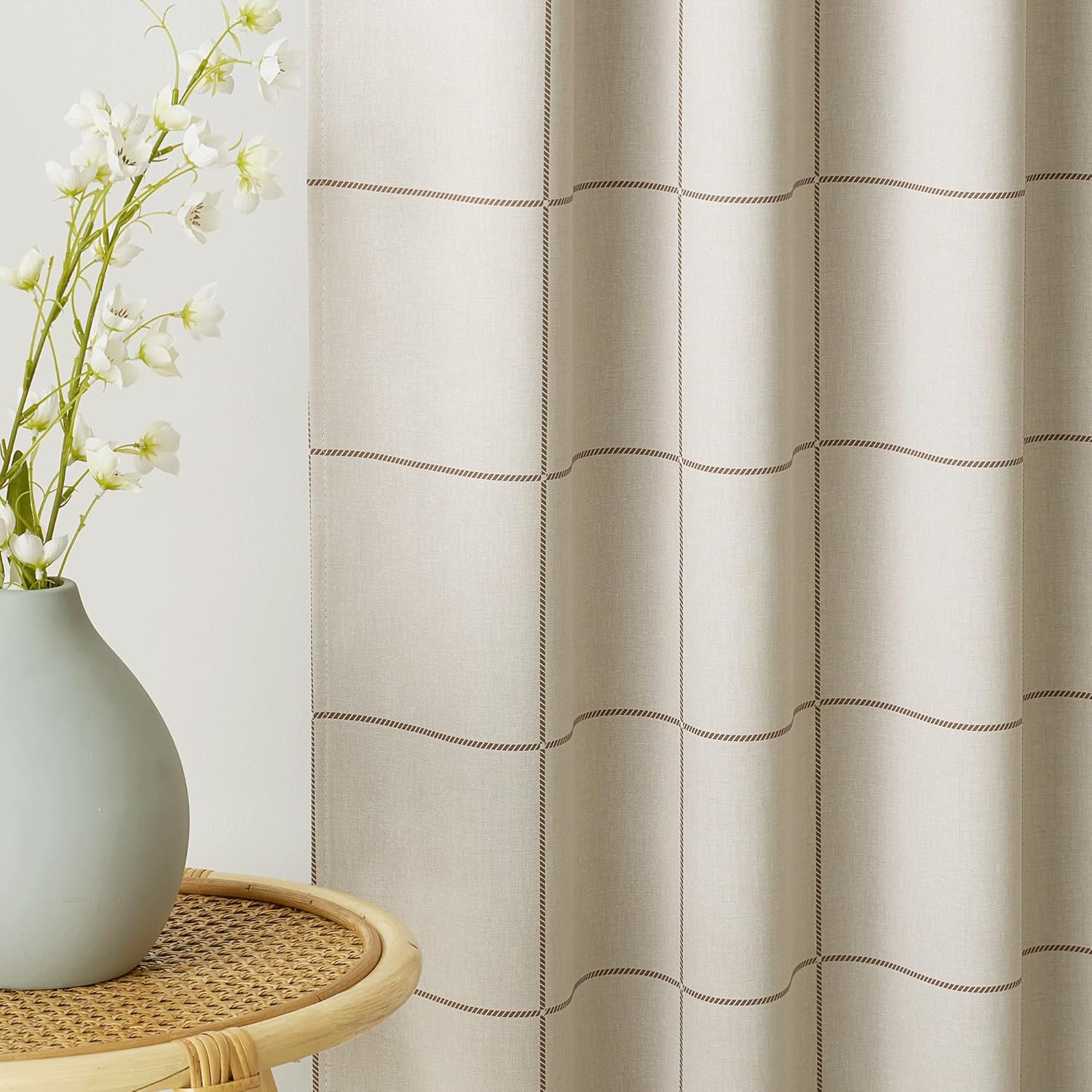 Natural beige linen curtain with a dark brown stitched grid pattern, creating a modern windowpane look.