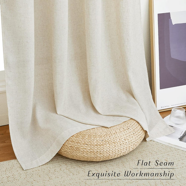 Natural beige linen-look window curtains with a textured weave, elegantly draped and pooling on a woven pouf.