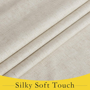 Close-up of natural beige woven fabric, showing soft folds and a textured linen-like surface.