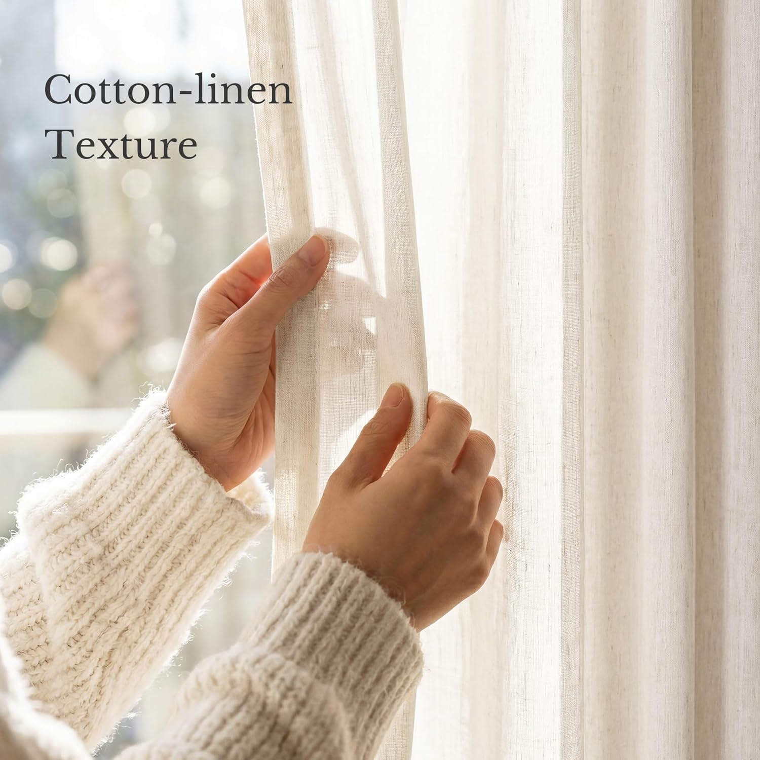 Hands touching light beige cotton-linen textured sheer curtain with natural sunlight filtering through.