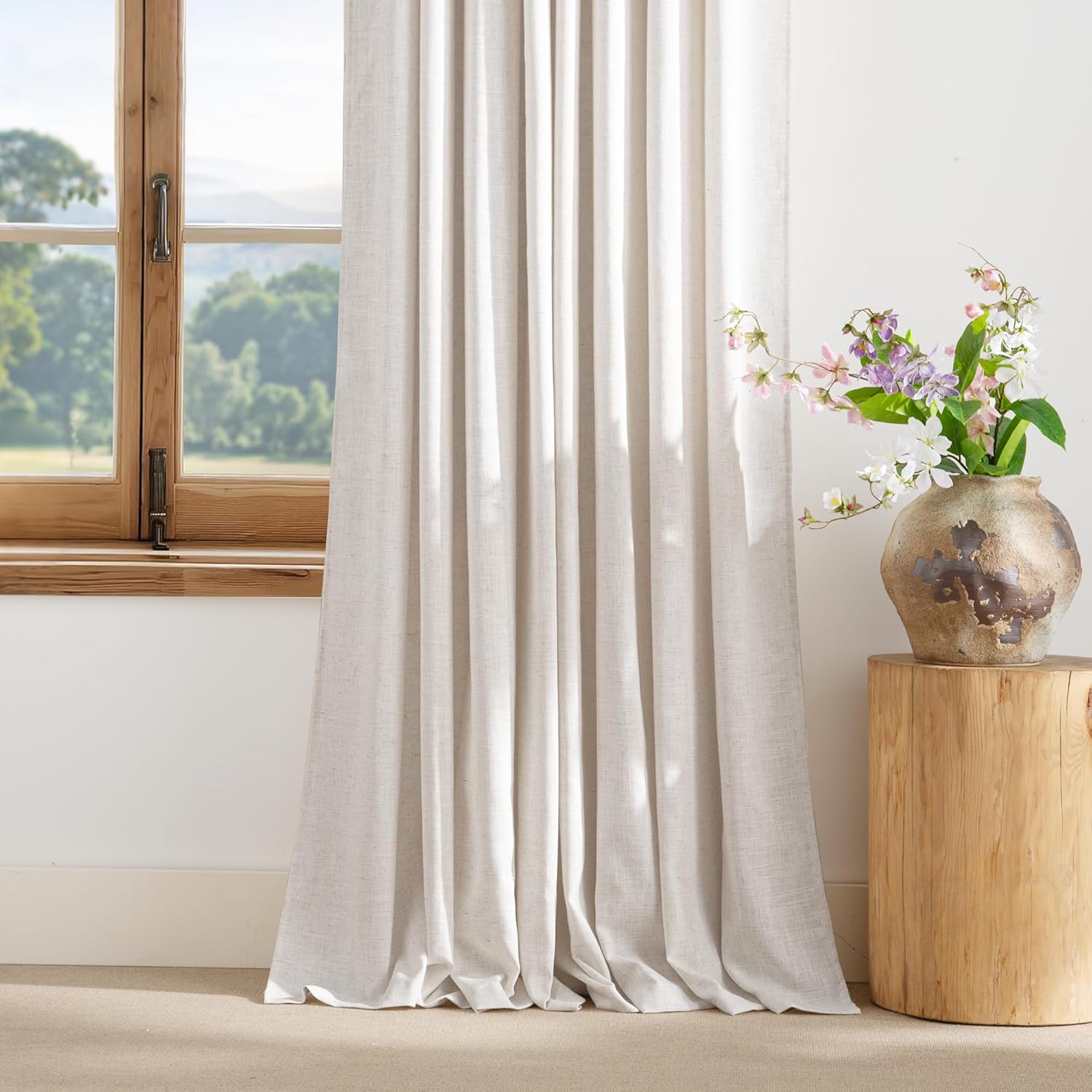 Light natural linen curtain panel, visible textured fabric, drapes floor-length.