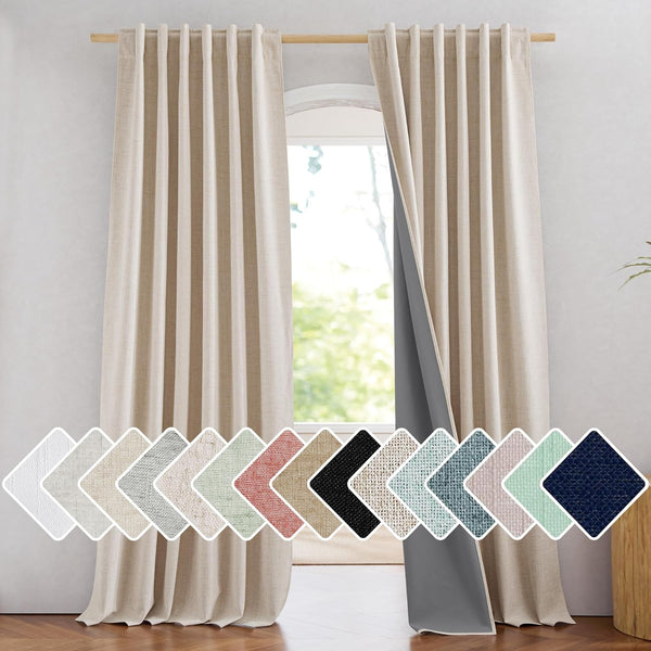 A pair of natural beige linen back tab blackout curtains hanging on a wooden rod, one pulled back revealing a dark grey thermal lining.