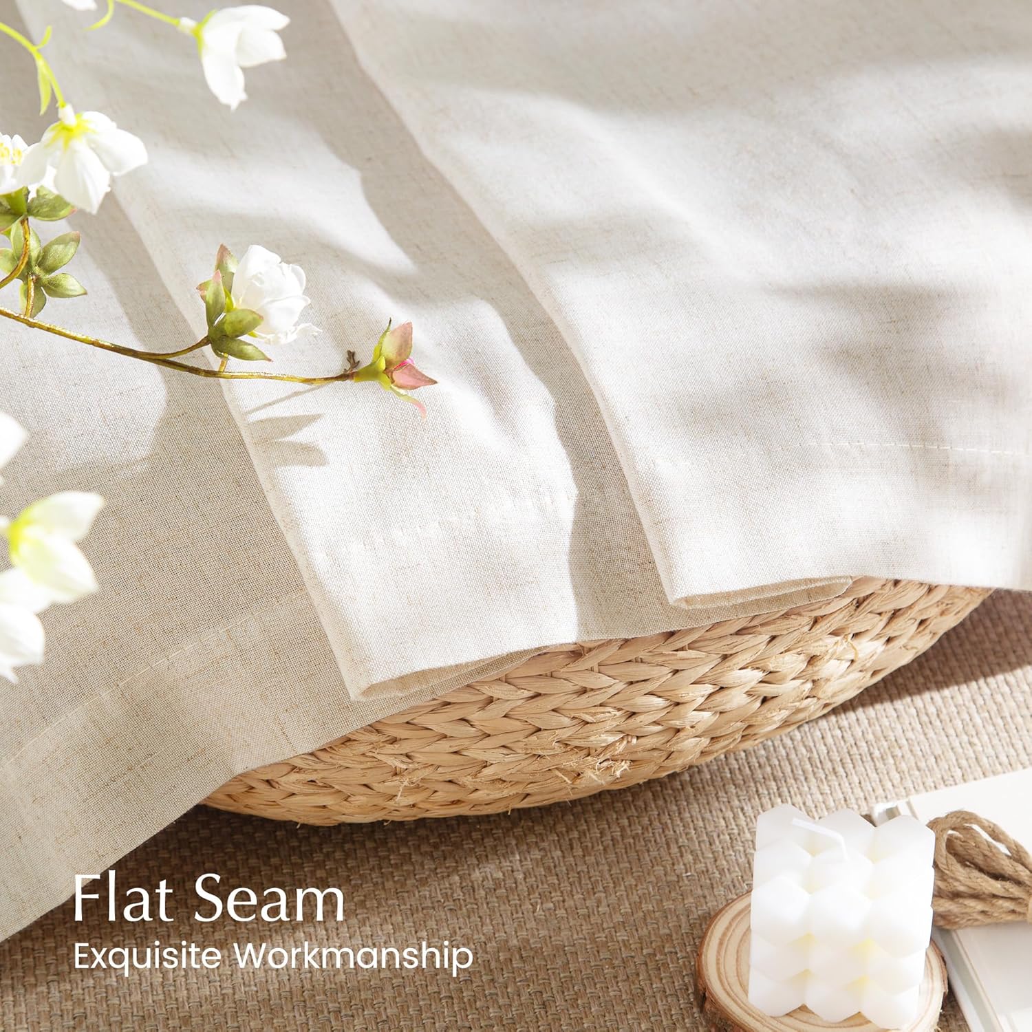 Close-up of natural linen-blend fabric in light beige, showcasing exquisite flat seam stitching draped over a woven basket.