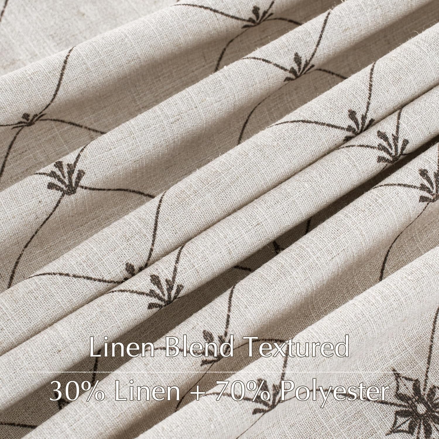 Close-up of natural beige linen blend textured fabric with a subtle dark brown floral vine pattern.
