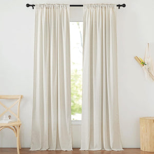 Light beige textured linen blend curtains with a rod pocket top, filtering sunlight into a rustic room.