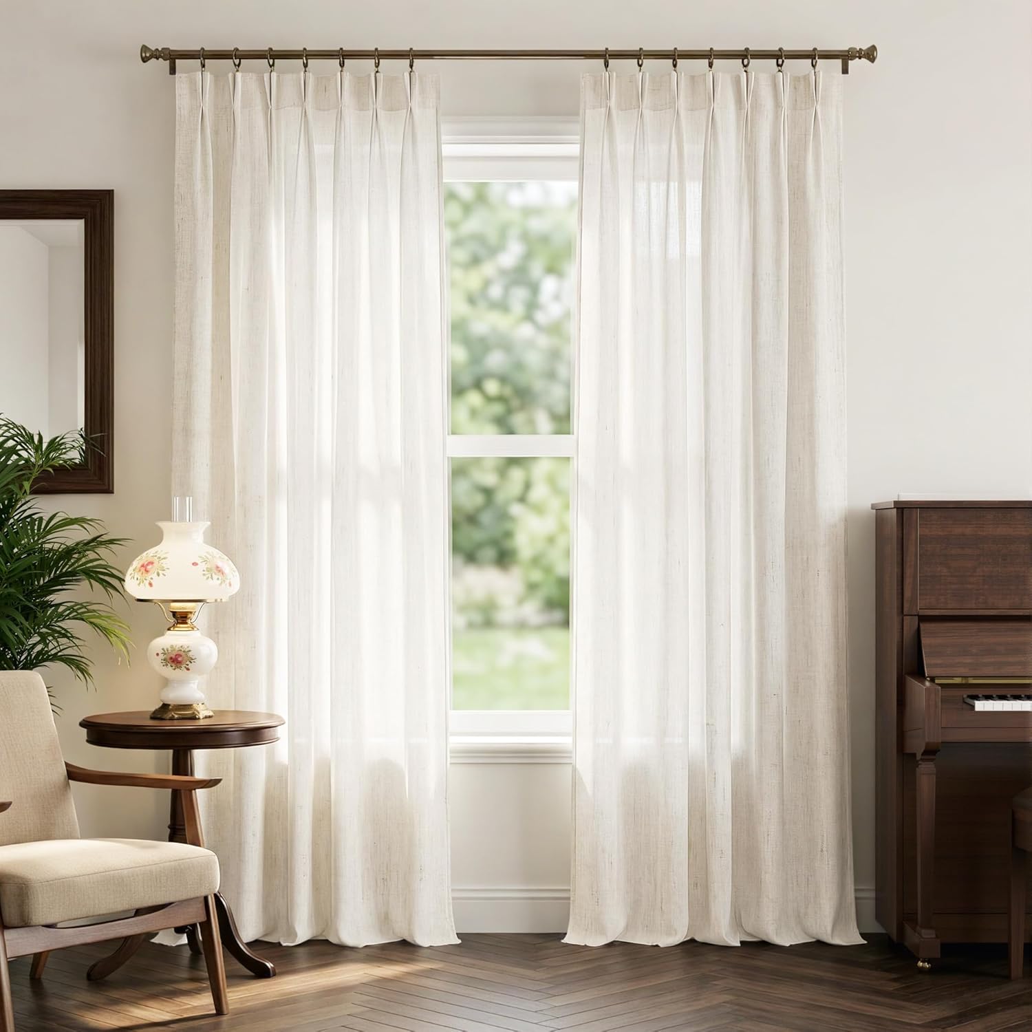 Light cream linen blend pinched pleat window curtains provide a soft, airy look in a living room.