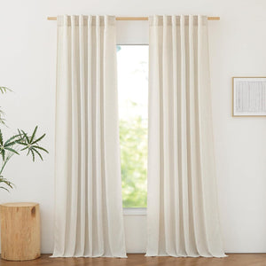 Pair of light beige natural linen blend curtains with rod pocket heading, gently filtering light.