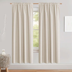 Pair of natural linen blend rod pocket curtains hanging on a wooden rod in a brightly lit room.