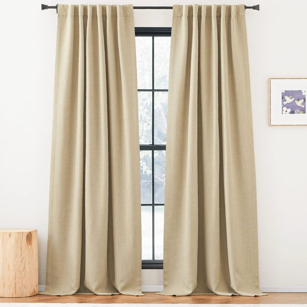 Natural beige linen blend curtains with gathered pleats hanging from a black rod over a tall window.